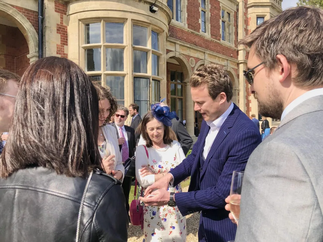 Richard Kettle performing close-up magic for guests outdoors