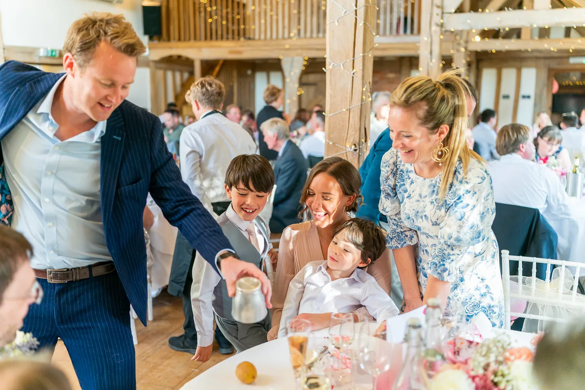 Richard Kettle performing close-up magic for a family at a wedding