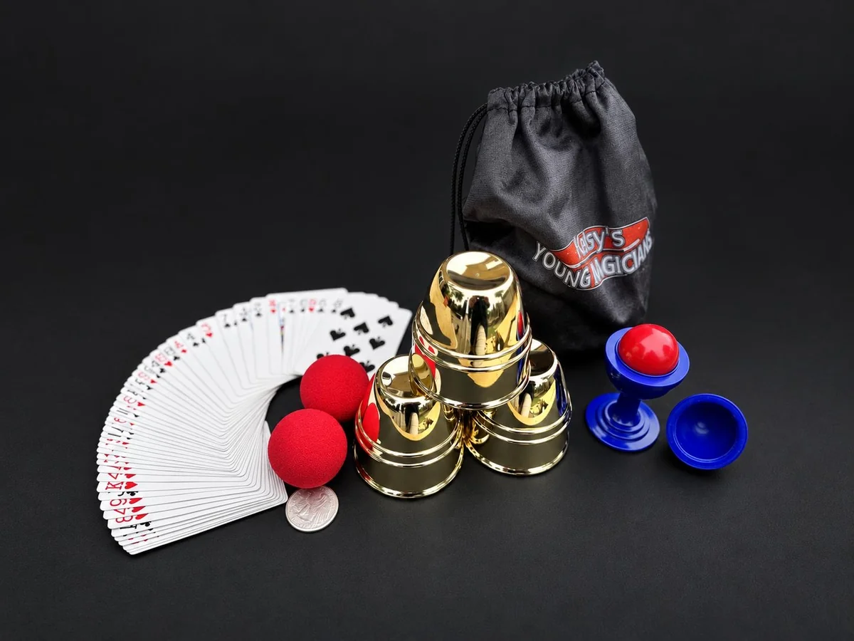The full Ketsy's Young Magicians party kit: playing cards, sponge balls, brass cups and balls, a ball and vase and a branded velvet bag