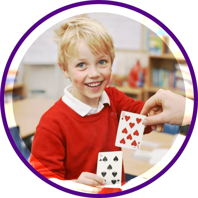 Boy performing a card trick at school