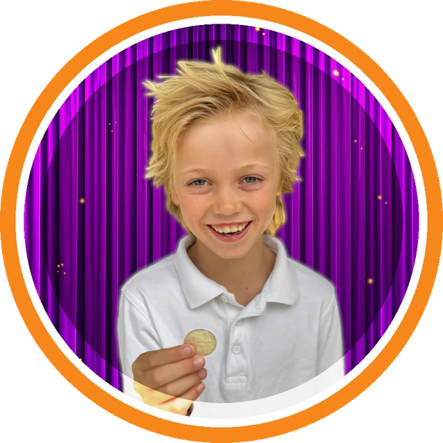 Boy showing a coin he has just made appear