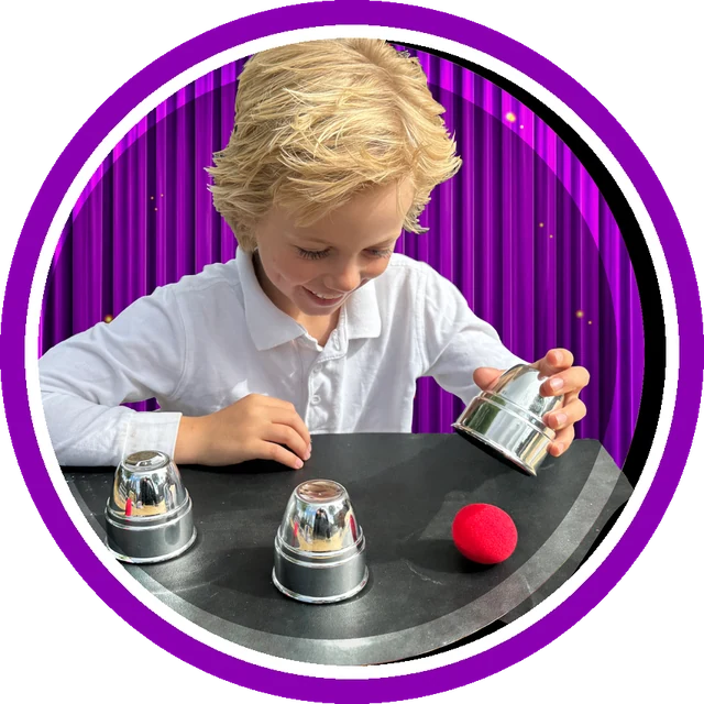Boy performing the cups and balls